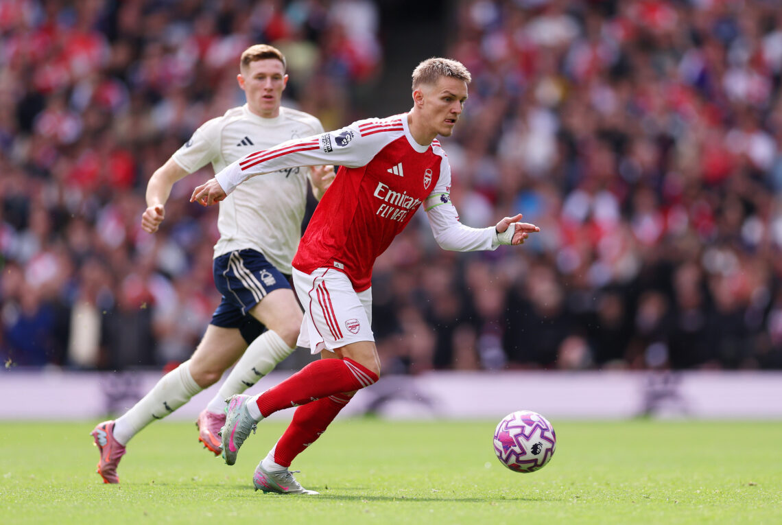 LONDON, ENGLAND - SEPTEMBER 13: Martin Odegaard of Arsenal runs with the ball from Elliot Anderson of Nottingham Forest during the Premier League m...
