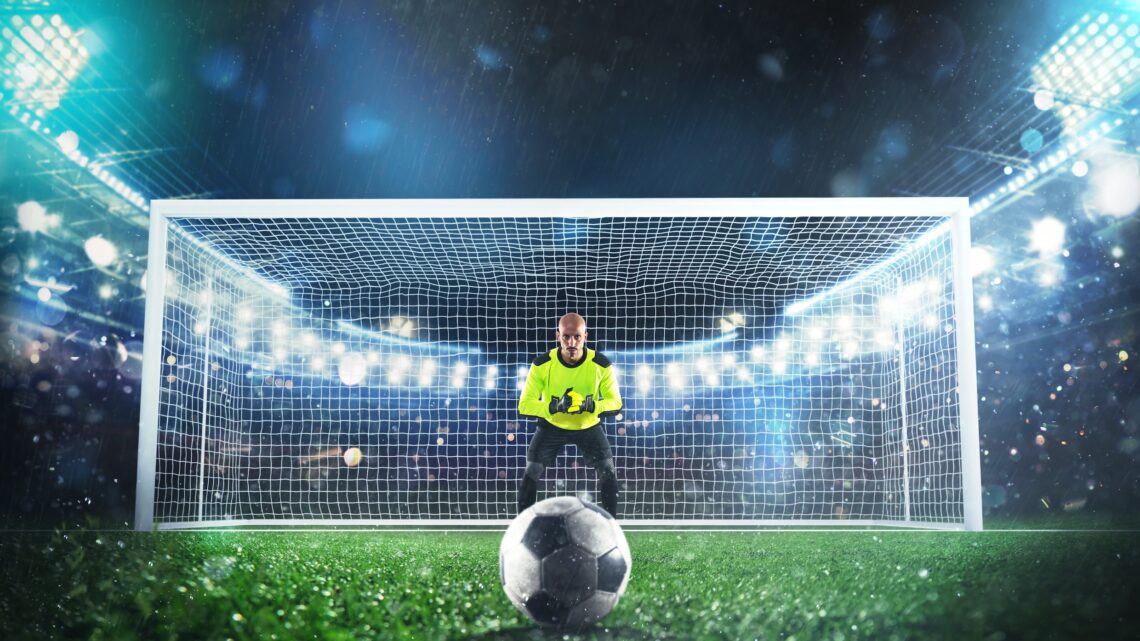 Football scene at night match, ball ready to be kicked