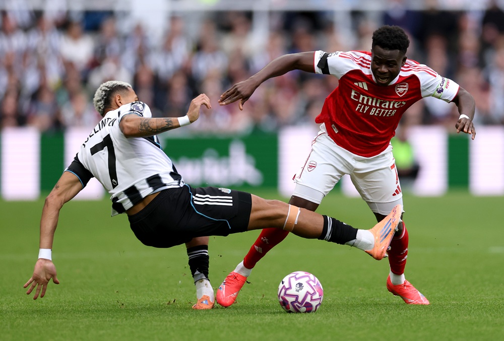 NEWCASTLE UPON TYNE, ENGLAND: Bukayo Saka of Arsenal is tackled by Joelinton of Newcastle United during the Premier League match between Newcastle ...