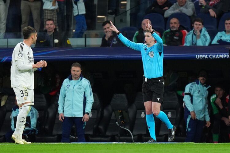 MADRID, SPAIN: Referee Francois Letexier gestures to overturn the penalty earlier awarded to Real Madrid following a VAR check during the UEFA Cham...