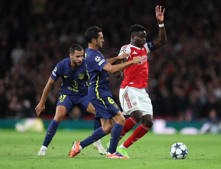 Bukayo Saka of Arsenal is tackled by Koke of Atletico de Madrid during the UEFA Champions League 2025/26 League Phase MD3 match between Arsenal FC ...