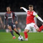 LONDON, ENGLAND: Martin Odegaard of Arsenal crosses the ball during the UEFA Champions League 2025/26 League Phase MD2 match between Arsenal FC and Olympiacos FC at Arsenal Stadium on October 01, 2025. (Photo by Mike Hewitt/Getty Images)