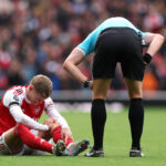 LONDON, ENGLAND - OCTOBER 04: Martin Odegaard of Arsenal goes down with an injury whilst holding his knee during the Premier League match between Arsenal and West Ham United at Emirates Stadium on October 04, 2025 in London, England. (Photo by Alex Pantling/Getty Images)