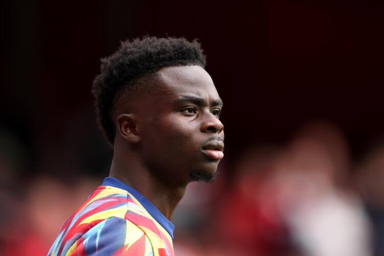 LONDON, ENGLAND - OCTOBER 04: Bukayo Saka of Arsenal looks on as he warms up prior to the Premier League match between Arsenal and West Ham United ...