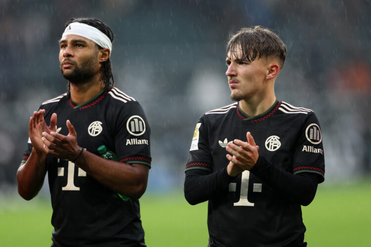 MOENCHENGLADBACH, GERMANY - OCTOBER 25: Serge Gnabry and Lennart Karl of Bayern Munich applaud the fans following the team's victory during the Bun...