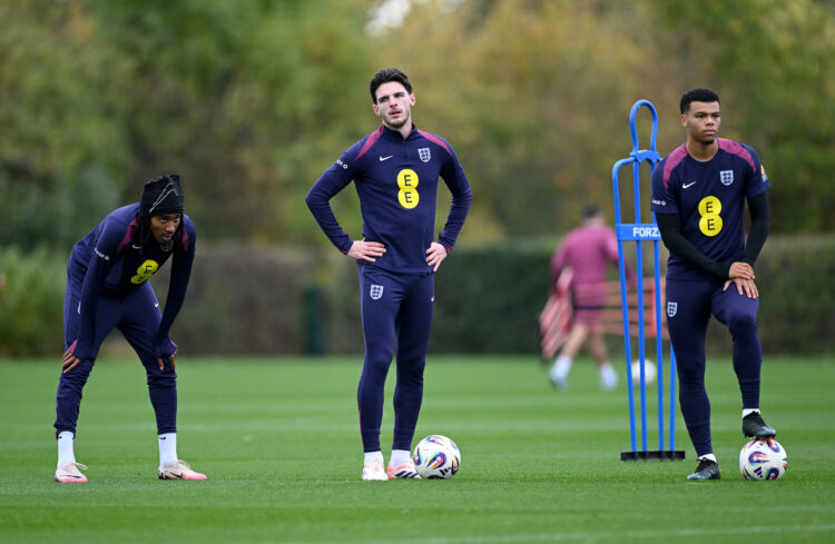 ENFIELD, ENGLAND - OCTOBER 13: Djed Spence, Declan Rice and Dane Scarlett of England look on during a training session at Tottenham Hotspur Trainin...