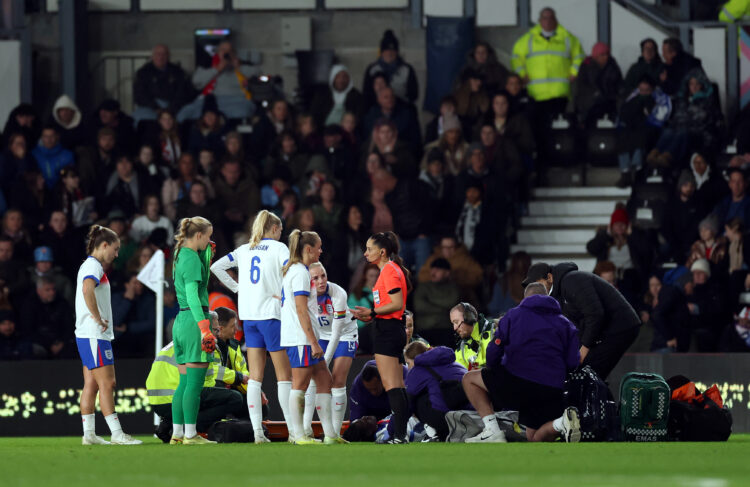 DERBY, ENGLAND - OCTOBER 28: Michelle Agyemang of England receives medical treatment before leaving the pitch on a stretcher during the Women's Int...