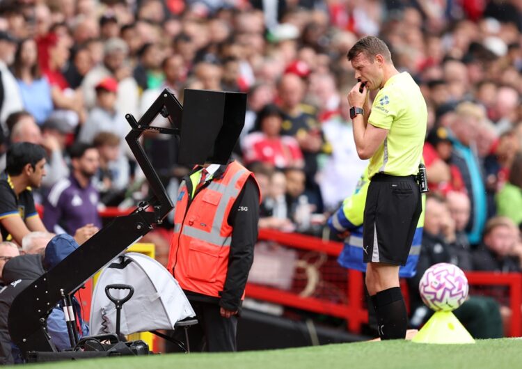 MANCHESTER, ENGLAND: Match referee Sam Barrott checks the VAR screen after Kyle Walker of Burnley (not pictured) fouls Mason Mount of Manchester Un...