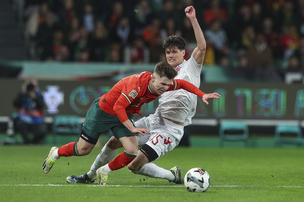 LISBON, PORTUGAL: Christian Norgaard of Denmark (R) tackles Francisco Conceicao of Portugal (L) during the UEFA Nations League Quarterfinal Leg Two match between Portugal and Denmark at Estadio Jose Alvalade on March 23, 2025. (Photo by Carlos Rodrigues/Getty Images)