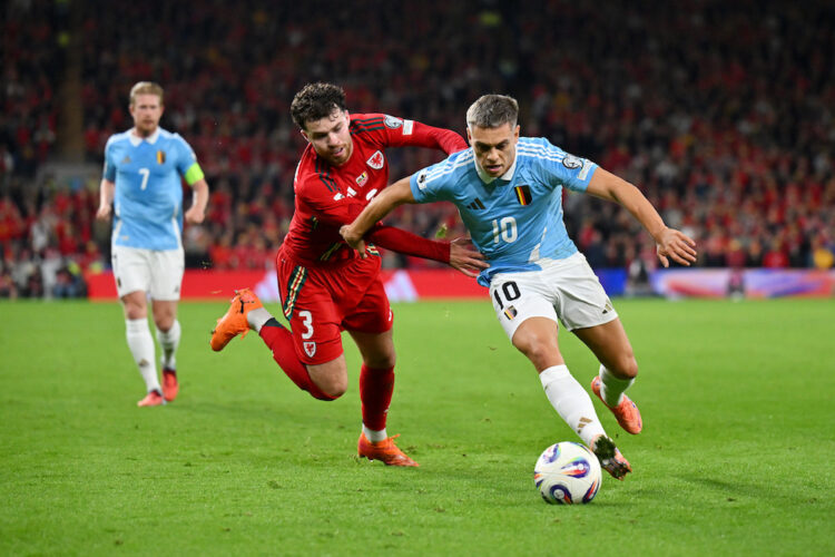 CARDIFF, WALES: Leandro Trossard of Belgium is challenged by Neco Williams of Wales during the Group J FIFA World Cup 2026 qualifier match between ...
