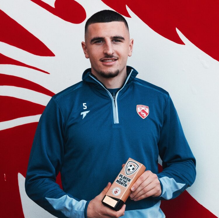 Maldini Kacurri with Morecambe's Player of the Month award for October (Photo via Morecambe FC on Instagram)