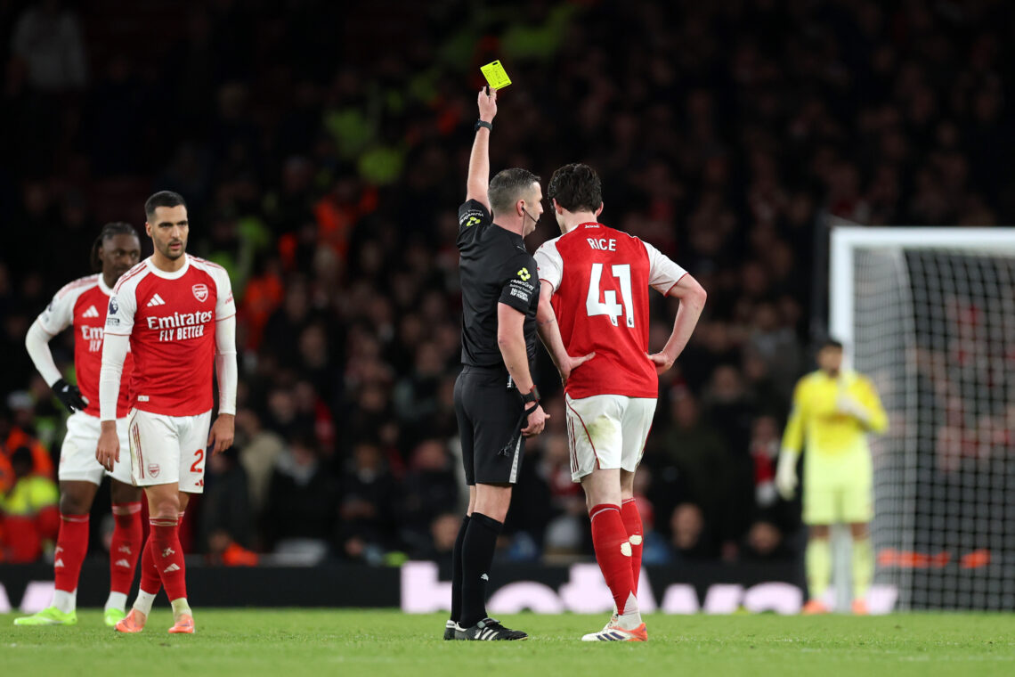 LONDON, ENGLAND - NOVEMBER 23: Referee Michael Oliver shows a yellow card to Declan Rice of Arsenal during the Premier League match between Arsenal...