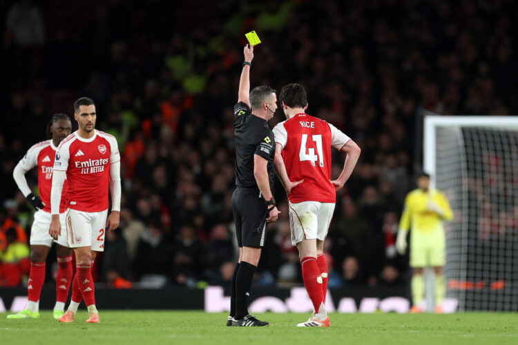 LONDON, ENGLAND - NOVEMBER 23: Referee Michael Oliver shows a yellow card to Declan Rice of Arsenal during the Premier League match between Arsenal...