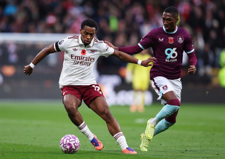 BURNLEY, ENGLAND: Jurrien Timber of Arsenal battles for possession with Jaidon Anthony of Burnley during the Premier League match between Burnley a...