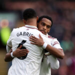 BURNLEY, ENGLAND - NOVEMBER 01: Jurrien Timber and Gabriel of Arsenal embrace prior to the Premier League match between Burnley and Arsenal at Turf Moor on November 01, 2025 in Burnley, England. (Photo by George Wood/Getty Images)