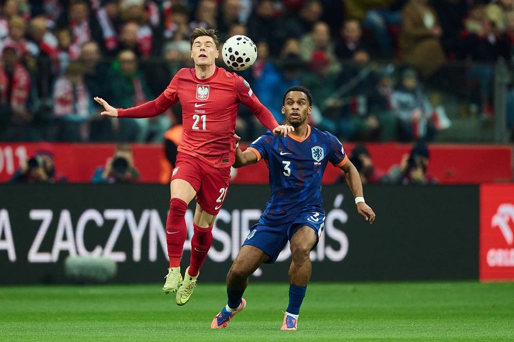 Arsenal international shakes off injury scare to qualify for World Cup 3 WARSAW, POLAND: Nicola Zalewski of Poland and Jurrien Timber of Netherlands fight for possession midair during the FIFA World Cup 2026 qualifier match between Poland and Netherlands at PGE Narodowy on November 14, 2025. (Photo by Rafal Oleksiewicz/Getty Images)