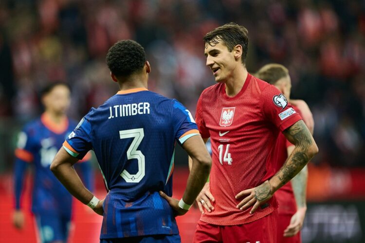 WARSAW, POLAND: Jurrien Timber of Netherlands speaks with Jakub Kiwior of Poland after the FIFA World Cup 2026 qualifier match between Poland and N...