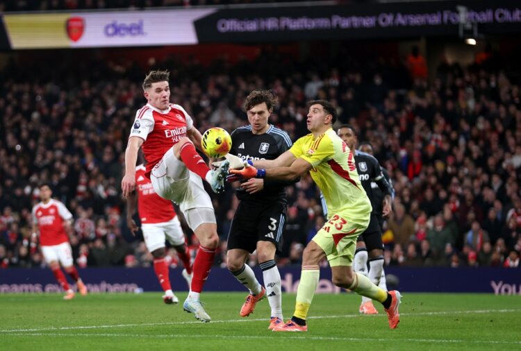 Viktor Gyoekeres of Arsenal clashes with Victor Lindeloef and Emiliano Martinez of Aston Villa during the Premier League match between Arsenal and ...