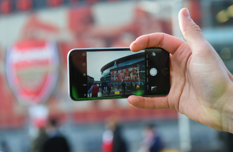 LONDON, ENGLAND - FEBRUARY 14: A fan photographs the stadium on his phone prior to the Barclays Premier League match between Arsenal and Leicester ...