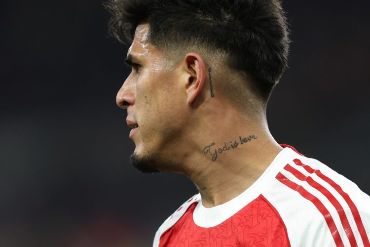LIVERPOOL, ENGLAND: A tattoo reading 'God is Love' on the neck of Piero Hincapie of Arsenal during the Premier League match between Everton and Ars...