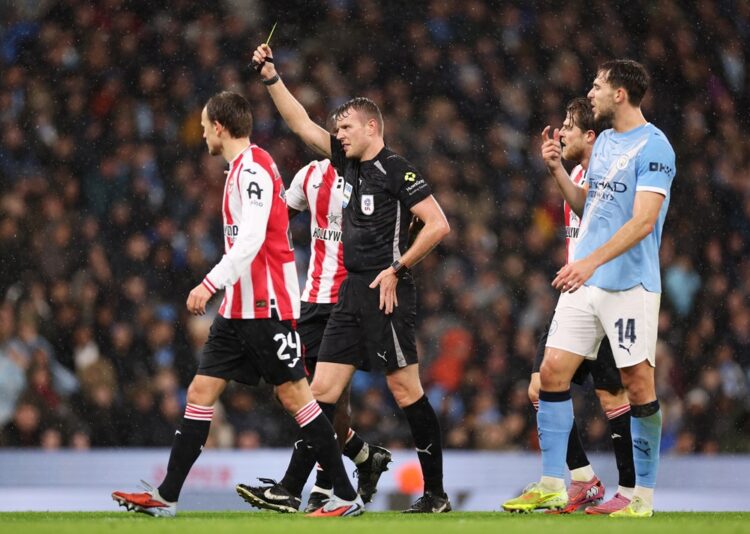 Brentford boss insists Manchester City deserved red card 2 MANCHESTER, ENGLAND: Referee Samuel Barrott shows Abdukodir Khusanov of Manchester City (not pictured) a yellow card during the Carabao Cup Quarter...