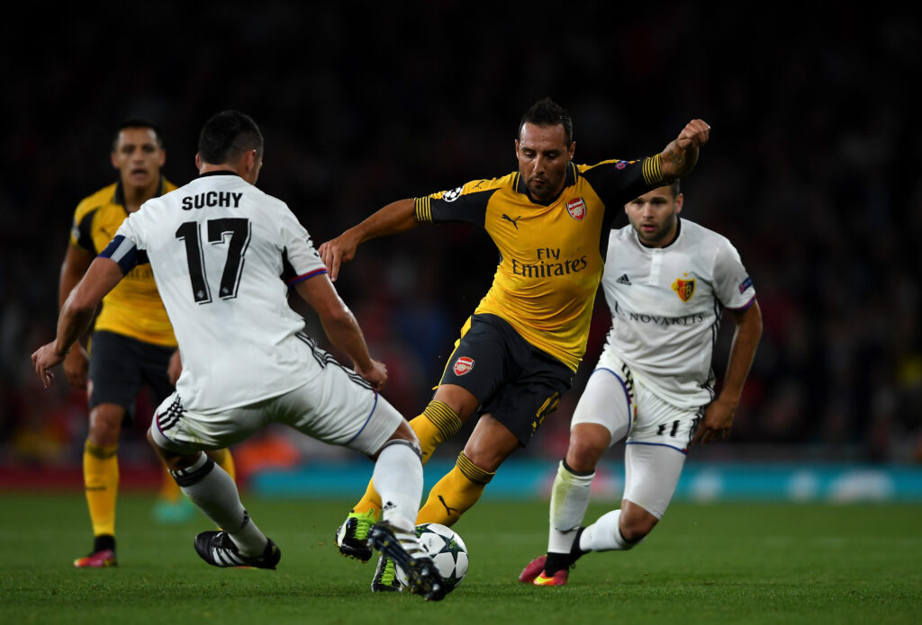LONDON, ENGLAND - SEPTEMBER 28: Santi Cazorla of Arsenal battles for the ball with Marek Suchy and Renato Steffen of Basel during the UEFA Champions League group A match between Arsenal FC and FC Basel 1893 at the Emirates Stadium on September 28, 2016 in London, England. (Photo by Mike Hewitt/Getty Images)