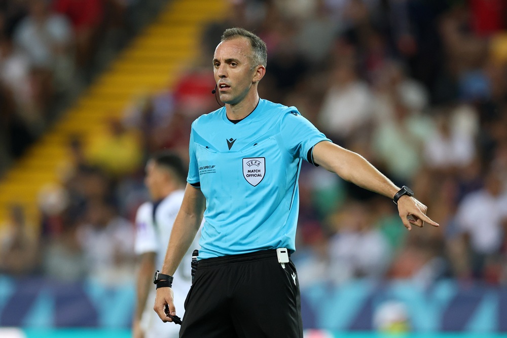 Referee Joao Pinheiro gestures during the UEFA Super Cup 2025 match between Paris Saint-Germain and Tottenham Hotspur at Stadio Friuli on August 13...