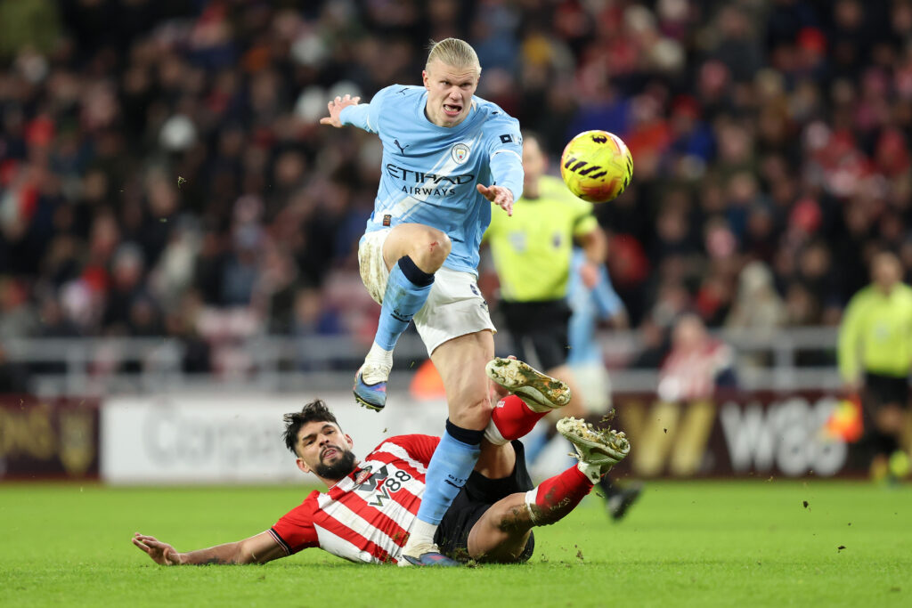 SUNDERLAND, ENGLAND - JANUARY 01: Omar Alderete of Sunderland tackles Erling Haaland of Manchester City during the Premier League match between Sunderland and Manchester City at Stadium of Light on January 01, 2026 in Sunderland, England. (Photo by Matt McNulty/Getty Images)