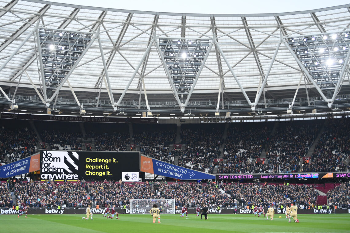 LONDON, ENGLAND - FEBRUARY 11: West Ham United and Chelsea FC players take a knee in support of the Black Lives Matter movement as an LED board rea...