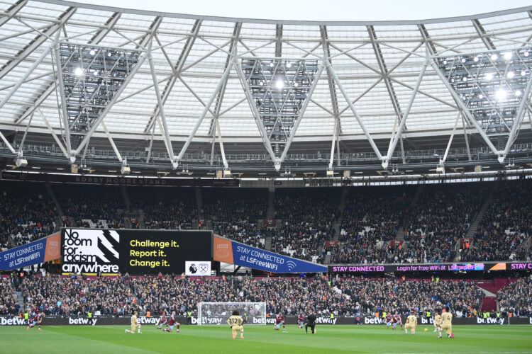 LONDON, ENGLAND - FEBRUARY 11: West Ham United and Chelsea FC players take a knee in support of the Black Lives Matter movement as an LED board rea...