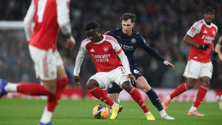 LONDON, ENGLAND: Bukayo Saka of Arsenal and Jensen Weir of Wigan Athletic during the Emirates FA Cup Fourth Round match between Arsenal and Wigan A...