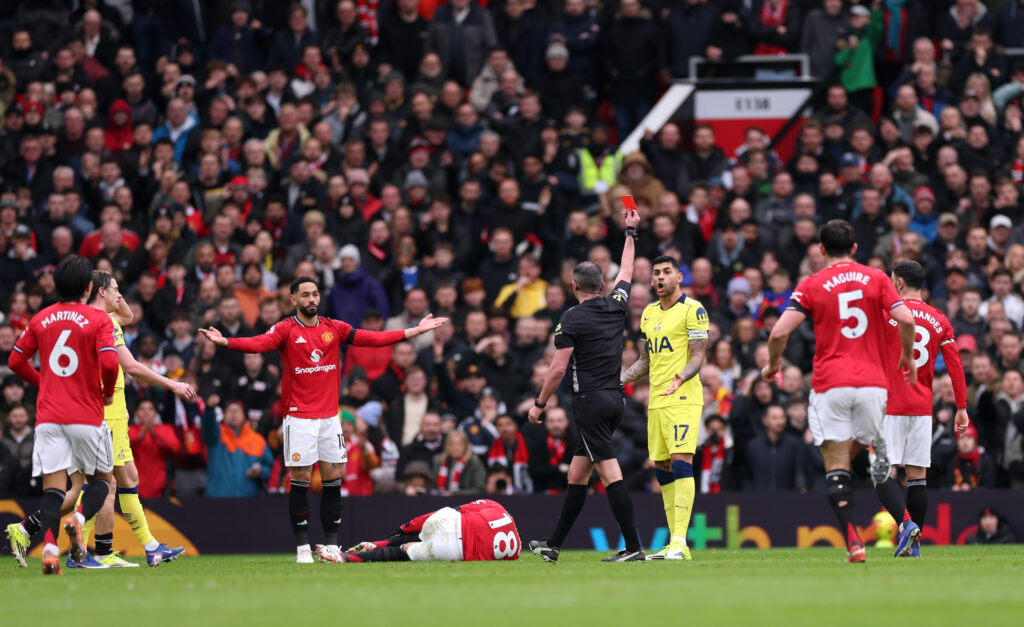 MANCHESTER, ENGLAND - FEBRUARY 07: Cristian Romero of Tottenham Hotspur is shown a red card by referee Michael Oliver after a foul on Casemiro of Manchester United during the Premier League match between Manchester United and Tottenham Hotspur at Old Trafford on February 07, 2026 in Manchester, England. (Photo by Carl Recine/Getty Images)