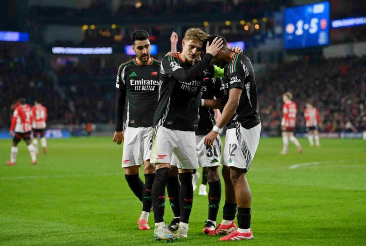 Martin Odegaard of Arsenal celebrates scoring his team's sixth goal with teammate Jurrien Timber during the UEFA Champions League 2024/25 UEFA Cham...
