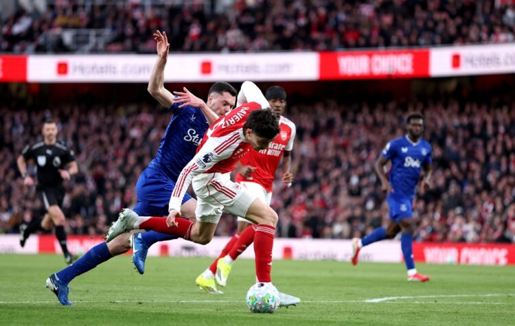 Kai Havertz of Arsenal is challenged by Michael Keane of Everton during the Premier League match between Arsenal and Everton at Emirates Stadium on...