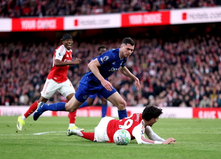 Kai Havertz of Arsenal is challenged by Michael Keane of Everton during the Premier League match between Arsenal and Everton at Emirates Stadium on...