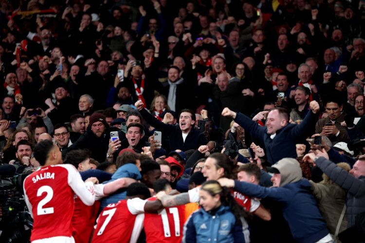 Max Dowman of Arsenal (obscured) celebrates scoring his team's second goal with teammates and fans during the Premier League match between Arsenal ...
