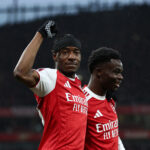 LONDON, ENGLAND - FEBRUARY 15: Noni Madueke of Arsenal celebrates with teammate Bukayo Saka after scoring his team's first goal during the Emirates FA Cup Fourth Round match between Arsenal and Wigan Athletic at the Emirates Stadium on February 15, 2026 in London, England. (Photo by James Fearn/Getty Images)