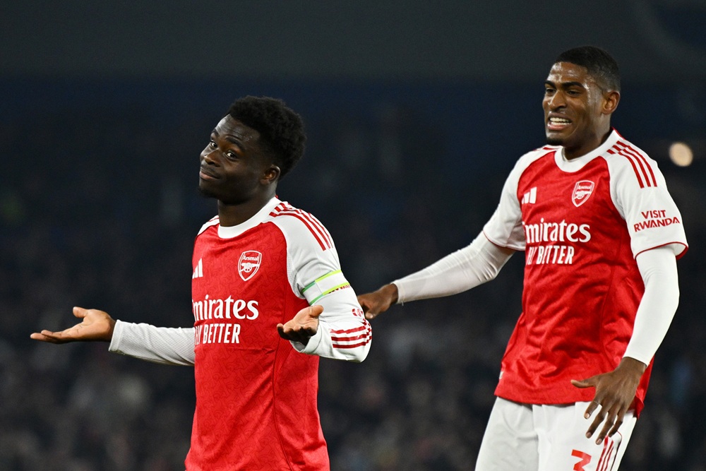 Bukayo Saka of Arsenal celebrates scoring his team's first goal with teammate Cristhian Mosquera during the Premier League match between Brighton &...