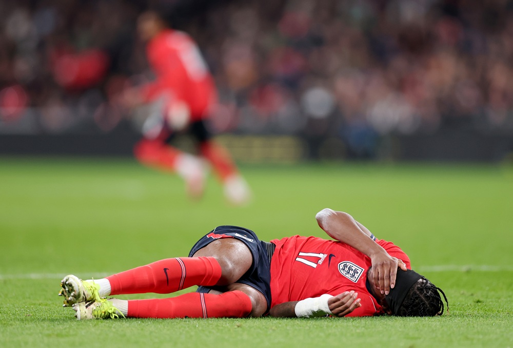 Noni Madueke of England reacts on the floor, which results in him being substituted due to a injury during the international friendly match between...