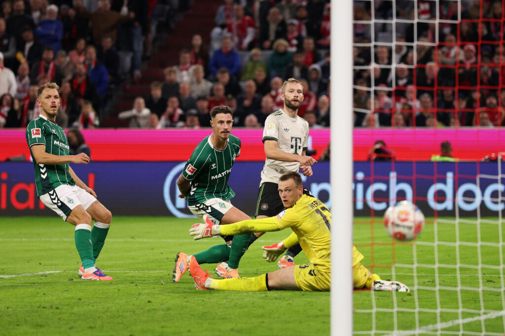 MUNICH, GERMANY - SEPTEMBER 26: Konrad Laimer of Bayern Munich scores his team's fourth goal past Karl Hein of Werder Bremen during the Bundesliga match between FC Bayern München and SV Werder Bremen at Allianz Arena on September 26, 2025 in Munich, Germany. (Photo by Adam Pretty/Getty Images)