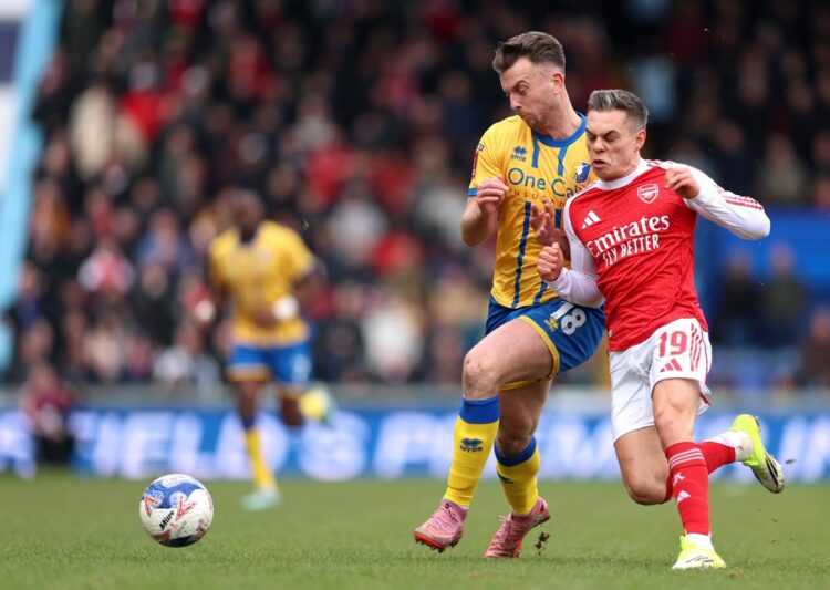 Rhys Oates of Mansfield Town and Leandro Trossard of Arsenal battle for possession during the Emirates FA Cup Fifth Round match between Mansfield T...