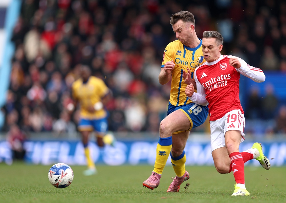 Rhys Oates of Mansfield Town and Leandro Trossard of Arsenal battle for possession during the Emirates FA Cup Fifth Round match between Mansfield T...