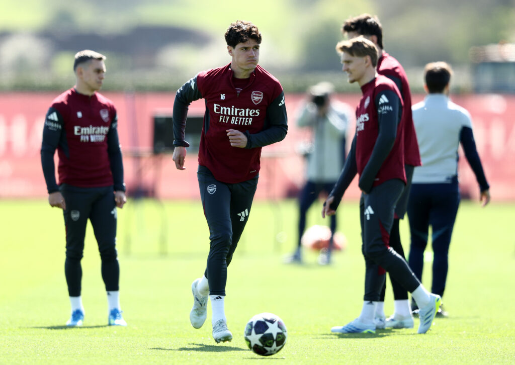 Christian Norgaard runs with the ball in Arsenal training and Leandro Trossard and Martin Odegaard stand behind him