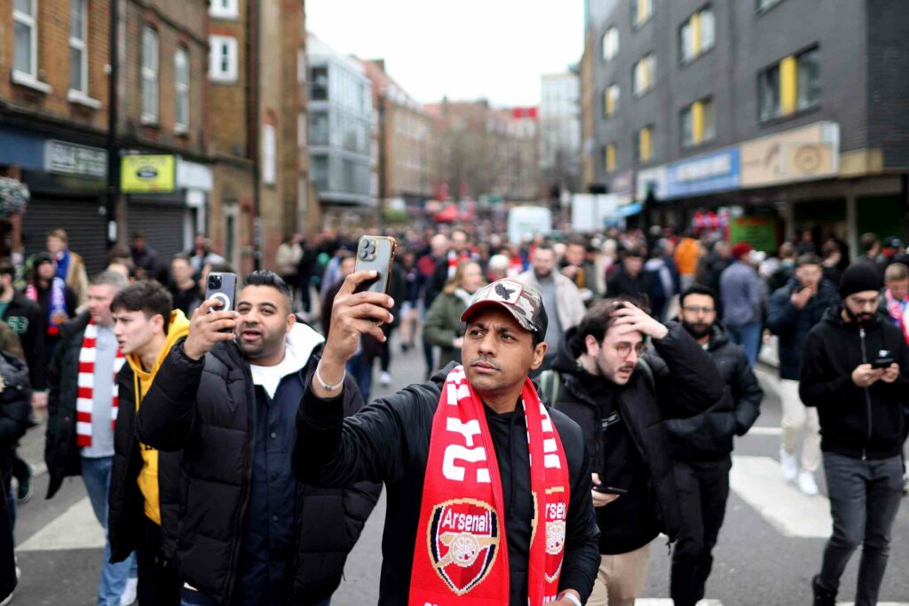LONDON, ENGLAND - MARCH 19: A fan of Arsenal takes a photograph on their mobile phone as they arrive prior to the Premier League match between Arsenal FC and Crystal Palace at Emirates Stadium on March 19, 2023 in London, England. (Photo by Ryan Pierse/Getty Images)