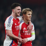 Declan Rice in an Arsenal kit with his arm around Martin Odegaard's shoulder