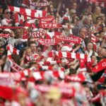 Arsenal fans raise their scarves as Arsenal women take on Lyon the CHampions League semi final first leg