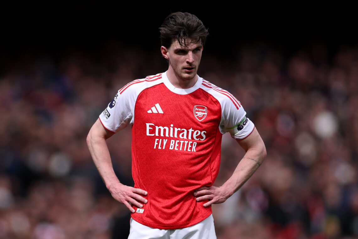 Declan Rice, in an Arsenal kit, stands with his hands on his hips