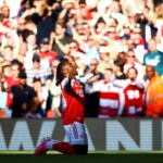 Eberechi Eze is on his knees with his hands raised to the heavens as he celebrates scoring a brilliant goal against Newcastle in front of an Arsenal squad bathed in April sunshine