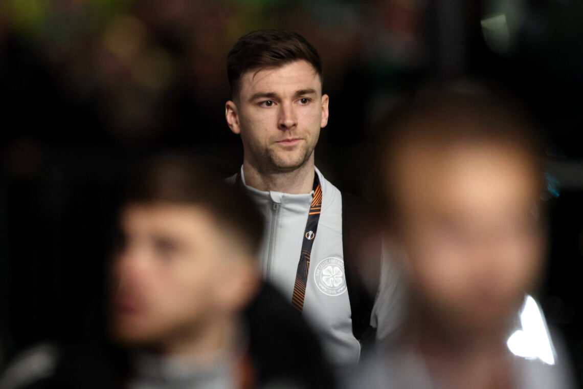 Kieran Tierney stands in the background as his teammates are blurred out in front of him