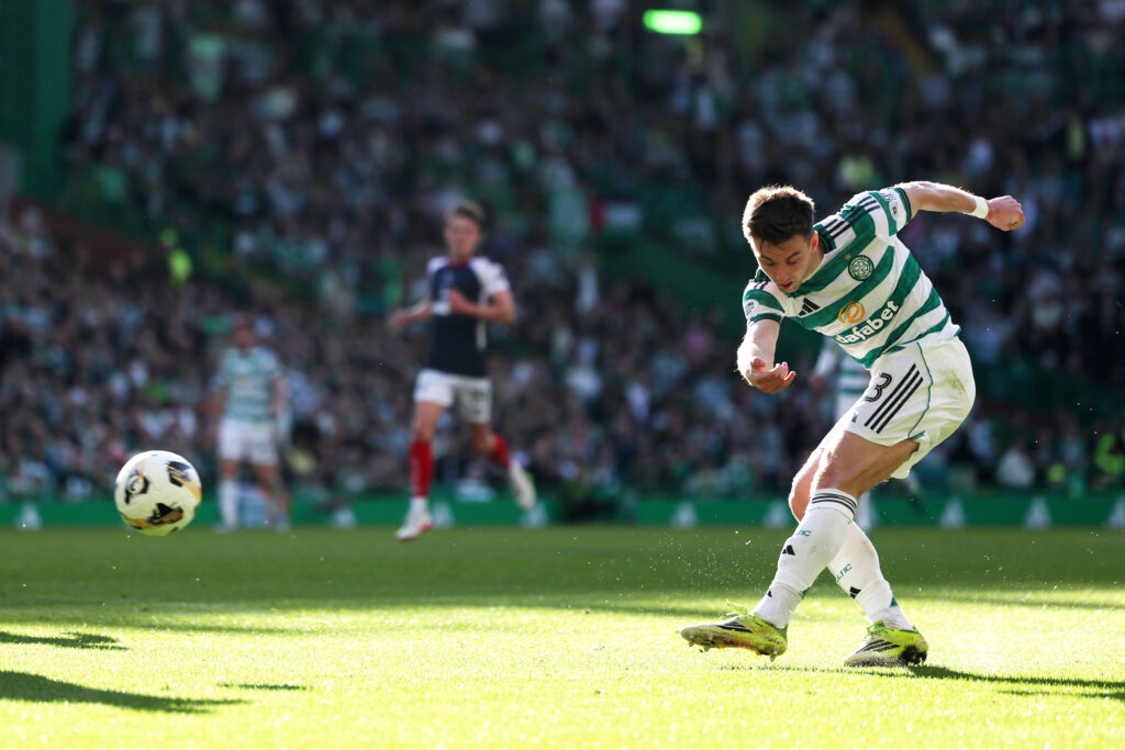 Kieran Tierney in a Celtic kit shoots at goal